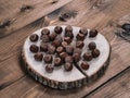 Unpeeled hazelnuts on a cracked wooden stand