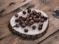 Unpeeled hazelnuts on a cracked wooden stand