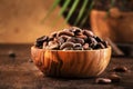 Unpeeled organic cocoa bean in bowl on wooden rustic table background. Copy space Royalty Free Stock Photo