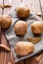 Unpeeled potatoes on a gray napkin