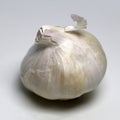 Unpeeled Whole Garlic on a White Table
