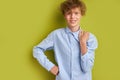 Unperturbed caucasian boy isolated over green background