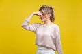 Unpleasant smell. Portrait of young dissatisfied woman with fair hair in casual beige blouse, isolated on yellow background