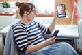 Unpleasant surprise .Young woman feels strong surprise, looking at table mirror, to which her face is reflected. Royalty Free Stock Photo