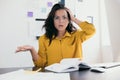 Unpleasantly surprised woman freelancer holding head. Lot of papers on desk. Notes and plans on background. Pretty women Royalty Free Stock Photo