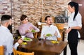 Unpleased client talking with manager in restaurant