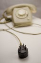 Unplugged analog gray telephone black connecting plug