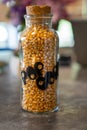 Unpopped Popcorn in vintage 1970s era glass jar with cork top.