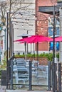 Unpopulated street cafe under red umbrellas on a winter season