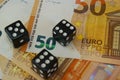 Unpredictable economic situation,concept. Three dice on new 50 euro banknotes, close up.