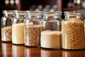 unprocessed whole grains in glass jars on a kitchen shelf