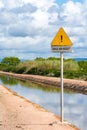 Unprotected channel yellow road sign in Sardinia