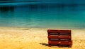 Unreal picture of the end of summer at a lake with an empty beach and a deck chair made of europallets Royalty Free Stock Photo