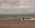 Unrecgonizable Woman walking on beach