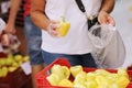 Unrecognisable adult woman chooses yellow pepers buys vegetables in a grocery store or supermarket, holds bio carrier