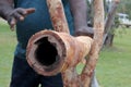 Aboriginal didgeridoo craftsman making Didgeridoo