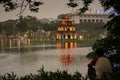 Unrecognisable man, the Hoan Kiem Lake and the turtle tower, Han