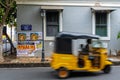 Unrecognisable man in a rickshaw in front of street sign