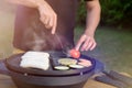 Unrecognisable man using electric grill. Garden grill party, summer barbecue Royalty Free Stock Photo