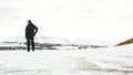 Unrecognisable senior man enjoying view , snow covered landscape, Edinburgh