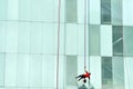 Unrecognisable windows cleaner cleaning an office building Royalty Free Stock Photo