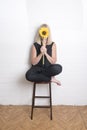 Unrecognisable woman hiding behind a sunflower Royalty Free Stock Photo