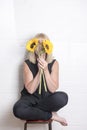 Unrecognisable woman hiding behind two sunflowers Royalty Free Stock Photo