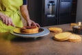 Unrecognisable woman spreding homemade jam on a delicious sponge cake. DIY, sequence, step by step, part of series. Royalty Free Stock Photo