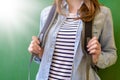 Unrecognisable young female high school student with rucksack leaning against blackboard at school. Back to school. Royalty Free Stock Photo