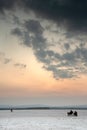 Unrecognised people enjoying the beautiful sunset over the empty dry salt lake of Larnaca in Cyprus