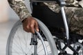 Unrecognizable african american soldier sitting in wheelchair