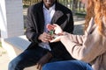 Unrecognizable african black man asking for her hand to his redhead caucasian girlfriend Royalty Free Stock Photo