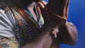 Unrecognizable African black man in traditional dress with rosary reading the Holy Bible Royalty Free Stock Photo