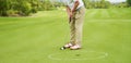 Unrecognizable man playing golf putting on green Royalty Free Stock Photo