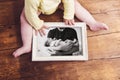 Unrecognizable baby holding picture frame. Fathers day. Royalty Free Stock Photo