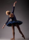 Unrecognizable ballerina in studio, blue tutu outfit. classical ballet art. back shot Royalty Free Stock Photo