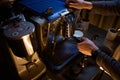 Barista with portafilter preparing aromatic drink in coffee machine