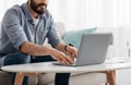 Unrecognizable bearded man working on pc, typing text or programming code on computer keyboard Royalty Free Stock Photo