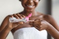 Unrecognizable black lady using micellar water, closeup Royalty Free Stock Photo