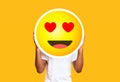 Unrecognizable black man hiding face against in love emoticon emoji