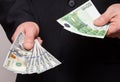 Unrecognizable businessman holding dollars and euro Royalty Free Stock Photo