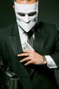 Unrecognizable businessman in a white mask hides or takes money from his breast pocket. Masked caucasian man holding Royalty Free Stock Photo