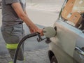 caucasian service woman at fuel station pumping petrol to a car Royalty Free Stock Photo