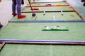 Unrecognizable children play miniature golf, children`s activities Royalty Free Stock Photo