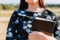 Unrecognizable christian girl holding a bible under her arm in the field. Sola scriptura. Copy space Royalty Free Stock Photo