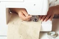 Cropped closeup hands of tailor woman using sewing machine, inserting textile pattern with stitch contours under needle Royalty Free Stock Photo