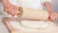 Unrecognizable cook's hands rolling out dough Royalty Free Stock Photo