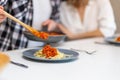 Unrecognizable couple having breakfast in kitchenn, man serving dinner, woman sitting at table. Royalty Free Stock Photo