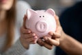 Unrecognizable Couple Holding Pink Piggybank In Hands, Saving Money For Future Royalty Free Stock Photo