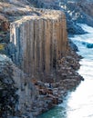 Unrecognizable couple inside basalt columns and river canyon